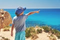 Child is looking to the sea being on the picturesque cliffy coast. Royalty Free Stock Photo