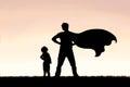 Child Looking up in Admiration to Cape Wearing Superhero Father Royalty Free Stock Photo