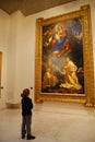 Child looking up at painting