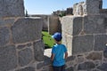 Child looking from the walls of Avila, Spain