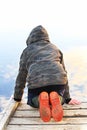 A child looking into water with a mirror reflection of the sky Royalty Free Stock Photo