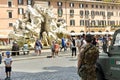 Child looks armed soldiers on patrol in Piazza Navona in Rome.