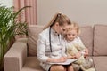 The child looks into the doctor clipboard. The curiosity of the child.