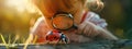 the child looks through a magnifying glass at the insect ladybug