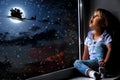 The child looks out the window into the night sky Royalty Free Stock Photo