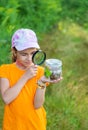 The child looks at the snail. Selective focus. Royalty Free Stock Photo