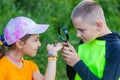 The child looks at the snail. Selective focus. Royalty Free Stock Photo