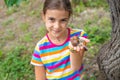The child looks at the snail. Selective focus. Royalty Free Stock Photo