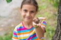The child looks at the snail. Selective focus. Royalty Free Stock Photo