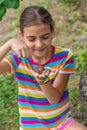 The child looks at the snail. Selective focus. Royalty Free Stock Photo