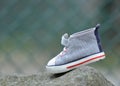 Child lost blue shoe with white sole on a rock in the middle of the hiking track Royalty Free Stock Photo