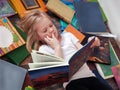 Child and a lot of books around.