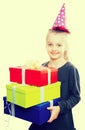 Child with a lot of gift boxes in hands on isolated background Royalty Free Stock Photo