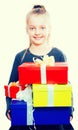 Child with a lot of gift boxes in hands on isolated background Royalty Free Stock Photo