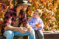 Child love. Childhood concept. Parent teach baby. Father and child son in autumn park having fun and laughing. Childhood