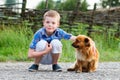 Child lovingly embraces his pet dog. Best friends. Outdoor