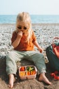 Child with lunch box outdoor eating vegan food on beach healthy lifestyle summer vacations kid girl with lunchbox container Royalty Free Stock Photo