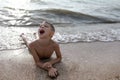 Child lying on beach of Azov sea Royalty Free Stock Photo