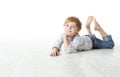 Child lying down on floor and looking at camera