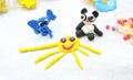 Child made elephant, panda and sun from plasticine, colorful modeling clay and sculpting funny animals . Home Education game with