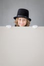 Child magician hiding behind banner blank Royalty Free Stock Photo