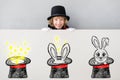 Child magician hiding behind banner blank Royalty Free Stock Photo