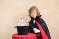 Child magician holding a top hat with toy rabbit Royalty Free Stock Photo