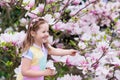 Child with magnolia flower. Little girl with flowers Royalty Free Stock Photo