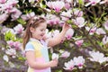 Child with magnolia flower. Little girl with flowers Royalty Free Stock Photo