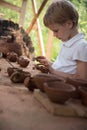 The child makes dishes and various figures from clay. Pottery skills. Hobbies and interests. Children`s education