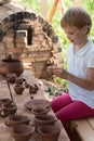 The child makes dishes and various figures from clay. Pottery skills. Hobbies and interests. Children`s education, expanding
