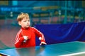 The child makes a feed in table tennis