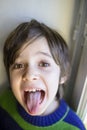 Child makes grimaces Royalty Free Stock Photo