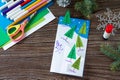 The child makes a greeting card Christmas. Made with his own hands. Children`s art project craft for kids. Royalty Free Stock Photo