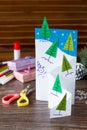 The child makes a greeting card Christmas. Made with his own hands. Children`s art project craft for kids. Royalty Free Stock Photo