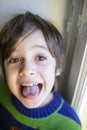 Child makes grimaces Royalty Free Stock Photo