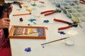 The child makes a panel of colored glass mosaic. Tools for creativity. Royalty Free Stock Photo