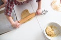 Child making cookies on the kitchen table.