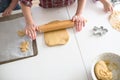 Child making cookies on the kitchen table.