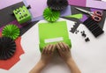 A child making decorum of Halloween from colored paper.