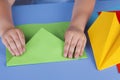 Child making a green paper plane Royalty Free Stock Photo