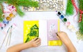 Child making a greeting card, Craft for children, Nice paper card with Chrictmas tree in yellow gray and green colours. . Top