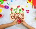 Child making harvesting of fresh red strawberry fruit from paper and plasticine, applique. Children development leisure learning