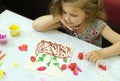 Child making harvesting of fresh red strawberry fruit from paper and plasticine, applique. Crafts for children. Children