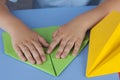 Child making a paper plane