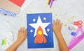 Child making rocket and stars from paper. Creative children play with craft. The space theme development of children. School