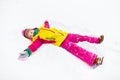 Child making snow angel. Kids play in winter park. Royalty Free Stock Photo