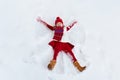 Child making snow angel. Kids winter outdoor fun Royalty Free Stock Photo