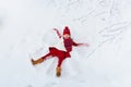 Child making snow angel. Kids winter outdoor fun Royalty Free Stock Photo