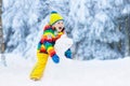 Child making snowman. Kids play in snow in winter Royalty Free Stock Photo